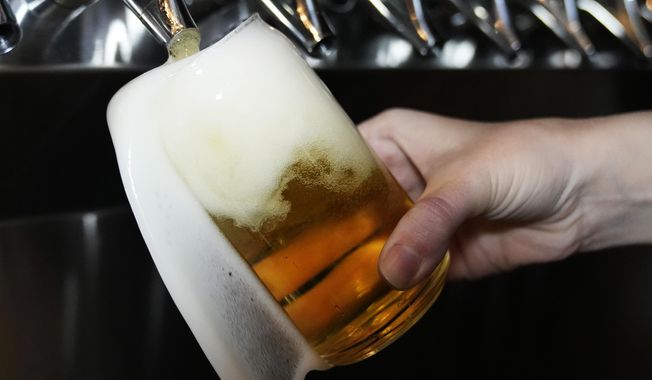 A bartender pours a craft beer in Buffalo Grove, Ill., Thursday, Feb. 9, 2022. (AP Photo/Nam Y. Huh, File)