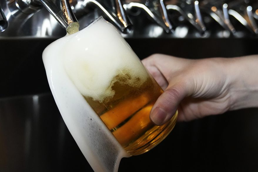 A bartender pours a craft beer in Buffalo Grove, Ill., Thursday, Feb. 9, 2022. (AP Photo/Nam Y. Huh, File)