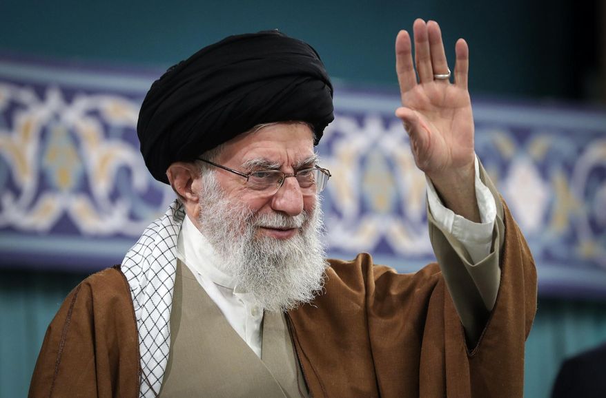In this photo released by the official website of the office of the Iranian supreme leader, Supreme Leader Ayatollah Ali Khamenei waves to the crowd during a meeting with officials, Islamic countries' ambassador to Iran and a group of people in Tehran, Iran, Monday, March 31, 2025. (Office of the Iranian Supreme Leader via AP)