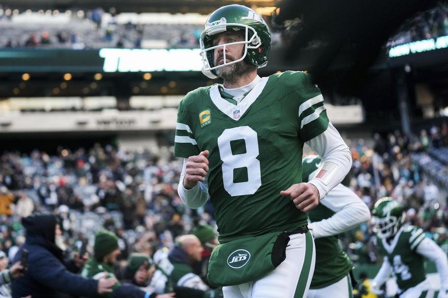 FILE - New York Jets quarterback Aaron Rodgers runs onto the field before an NFL football game against the Miami Dolphins, Sunday, Jan. 5, 2025, in East Rutherford, N.J. (AP Photo/Seth Wenig, File)