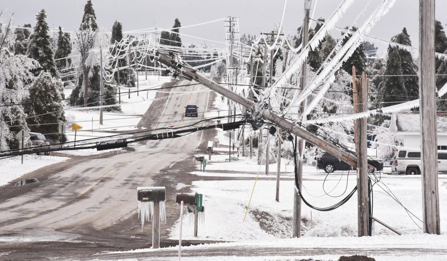 Wilkinson Road is blocked by downed power lines on Monday, March 31, 2025. (John L. Russell /Detroit News via AP)