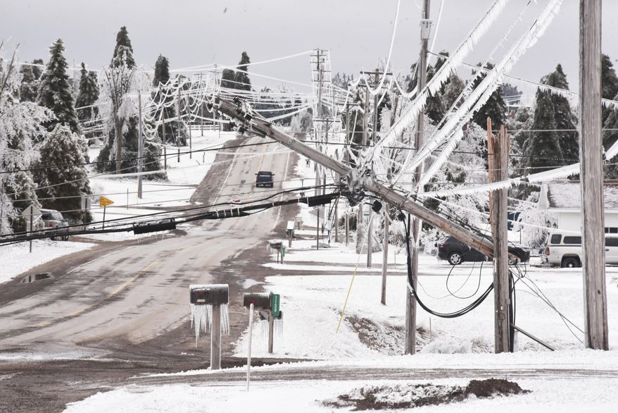 Wilkinson Road is blocked by downed power lines on Monday, March 31, 2025. (John L. Russell /Detroit News via AP)