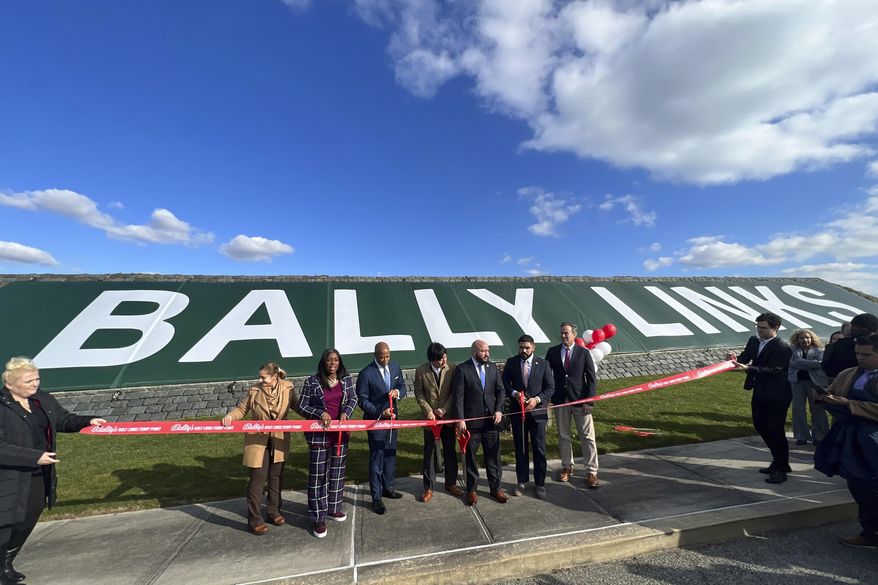 FILE - In this photo provided by the Office of the Mayor of New York, Mayor Eric Adams, third left, participates in the ribbon cutting ceremony and sign unveiling of Bally Links, formerly Trump Links, at Ferry Point in the Bronx borough of New York, Thursday, Jan. 11, 2024. (Michael Appleton/Mayoral Photography Office via AP, File)