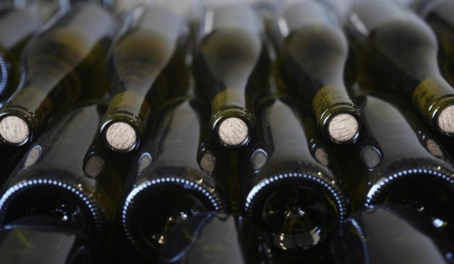 Bottles of Chablis wine are stored at the wine-making facility of winegrower Vincent Dampt, in Chablis, Burgundy region, eastern France, Thursday, April 3, 2025. (AP Photo/Thibault Camus) ** FILE **