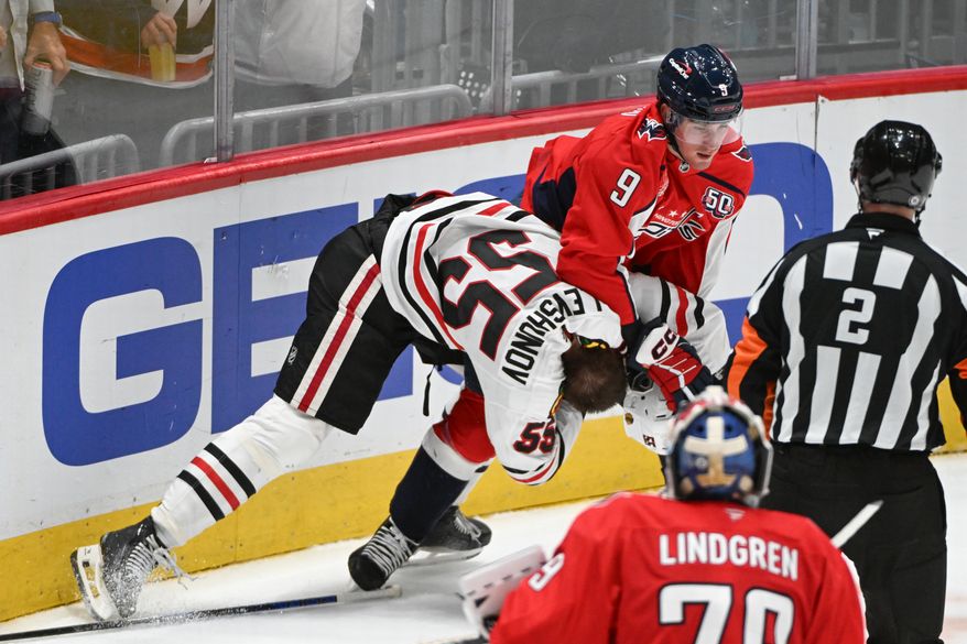 Washington Capitals forward Ryan Leonard (9) taking down Chicago Blackhawks defenseman Artyom Levshunov (55) during the second period of an NHL game at Capital One Arena in Washington D.C., April 4, 2025. (Photo for the Washington Times)