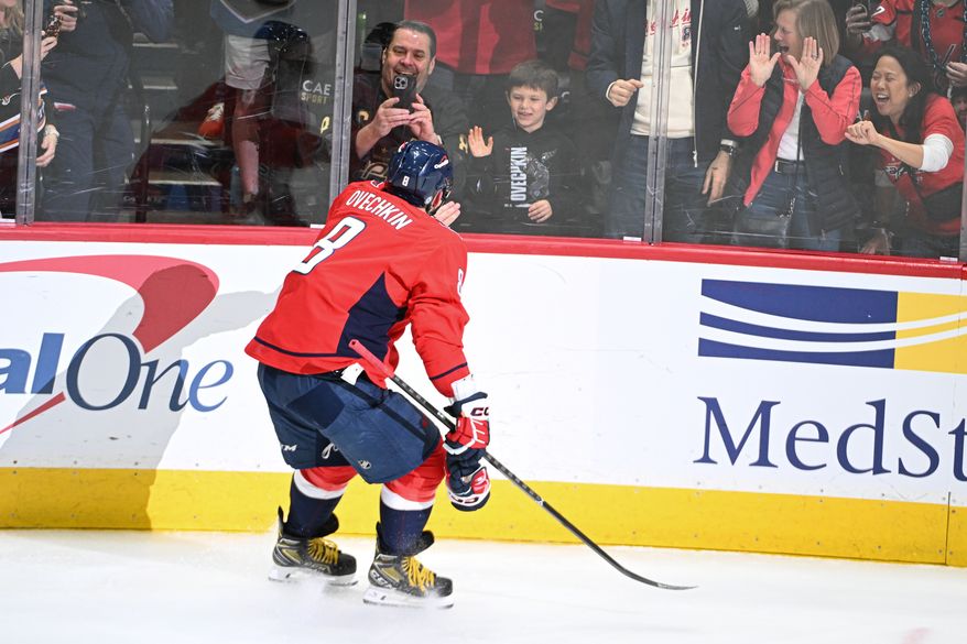 Washington Capitals left wing Alex Ovechkin (8) skating over to high-five his son Sergei scoring goal 894 during the third period of an NHL game against the Chicago Blackhawks at Capital One Arena in Washington D.C., April 4, 2025. (Photo for the Washington Times)