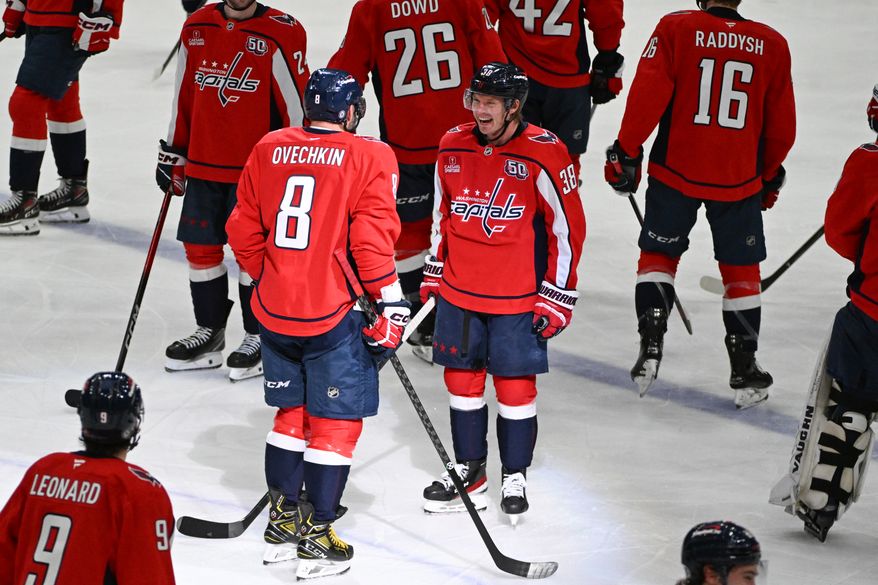 Washington Capitals left wing Alex Ovechkin (8) getting greeted by Washington Capitals defenseman Rasmus Sandin (38) after scoring goal 894 during the third period of an NHL game against the Chicago Blackhawks at Capital One Arena in Washington D.C., April 4, 2025. (Photo for the Washington Times)