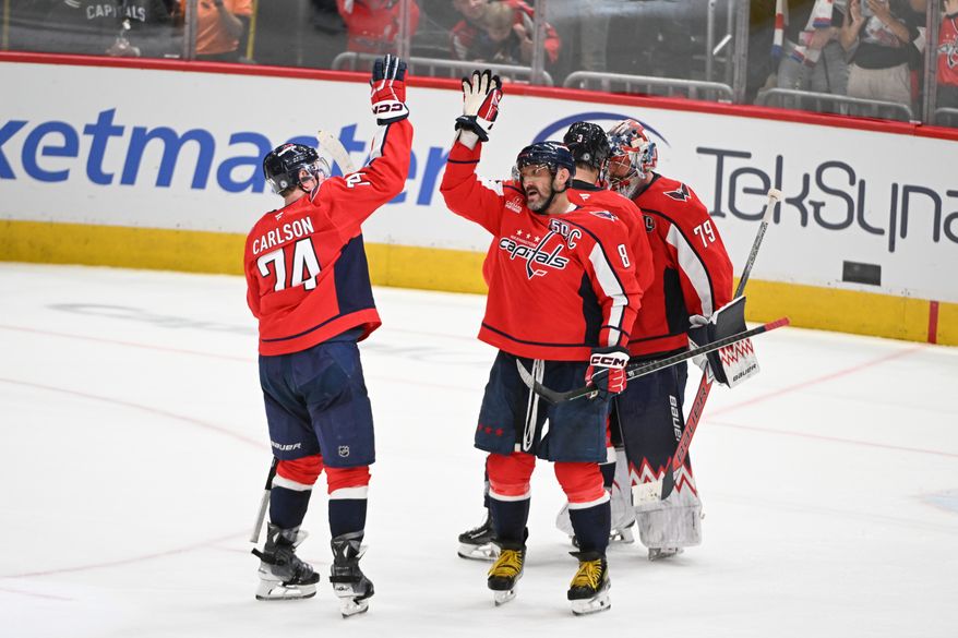 Washington Capitals left wing Alex Ovechkin (8) greeting teammate John Carlson (74) after the team’s 5-3 win over the Chicago Blackhawks at Capital One Arena in Washington D.C., April 4, 2025. Ovechkin scored goal number 894 in the win. (Photo for the Washington Times)