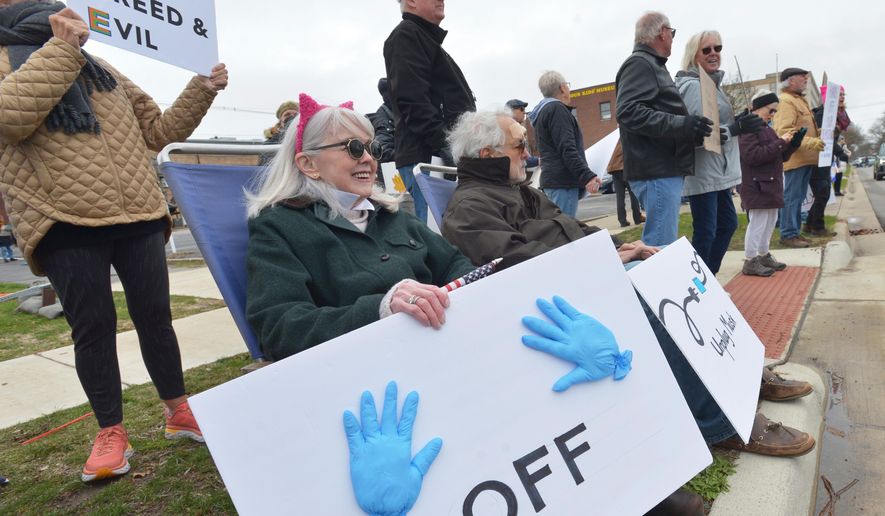 Hundreds of people gather in downtown St. Joseph, Mich., Saturday, April 5, 2025, during a "Hands Off" rally held to protest the Trump administration and recent DOGE cuts. (Don Campbell/The Herald-Palladium via AP) **FILE**