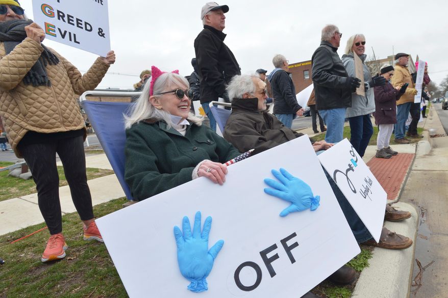 Hundreds of people gather in downtown St. Joseph, Mich., Saturday, April 5, 2025, during a "Hands Off" rally held to protest the Trump administration and recent DOGE cuts. (Don Campbell/The Herald-Palladium via AP) **FILE**