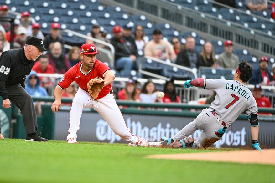 Arizona Diamondbacks right fielder Corbin Carroll (7) sliding into third as Washington Nationals third baseman Paul DeJong (14) awaits the throw after hitting a lead off triple during the first inning of an MLB game at Nationals Park in Washington D.C., April 6, 2025. (Photo by All-Pro Reels for Washington Times Sports)