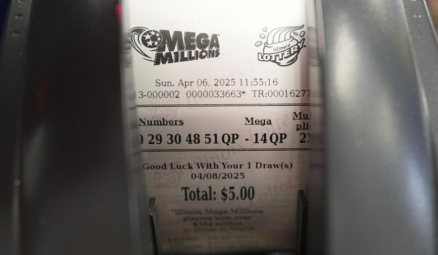 A Mega Millions lottery ticket is printed out of a lottery machine at Mares Mart in Chicago, Sunday, April 6, 2025. (AP Photo/Nam Y. Huh)