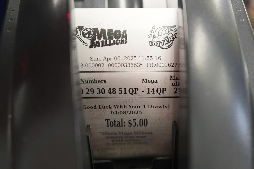 A Mega Millions lottery ticket is printed out of a lottery machine at Mares Mart in Chicago, Sunday, April 6, 2025. (AP Photo/Nam Y. Huh)