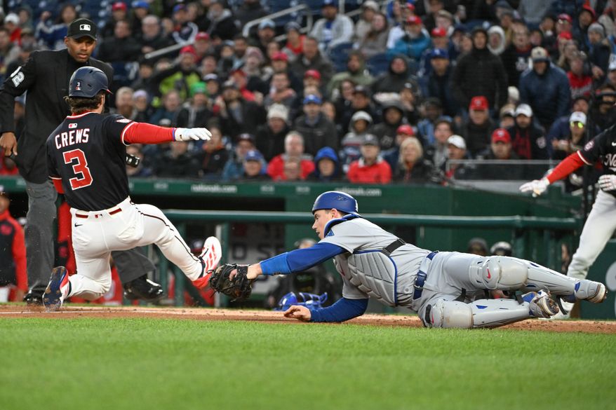 Washington Nationals right fielder Dylan Crews (3) sliding safely into home during the second inning of an MLB game against the Los Angeles Dodgers at Nationals Park in Washington D.C., April 7, 2025. (Photo by All-Pro Reels for Washington Times Sports)