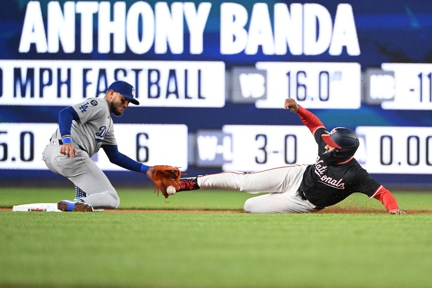 Washington Nationals second baseman Amed Rosario (13) sliding into second with a stolen base during the seventh inning of an MLB game against the Los Angeles Dodgers at Nationals Park in Washington D.C., April 7, 2025. (Photo by All-Pro Reels for Washington Times Sports)