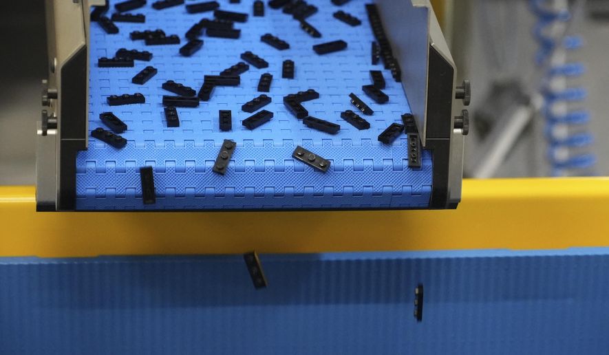 Lego bricks are moved on conveyor belt at Lego factory in Binh Duong, Vietnam Wednesday, April 2, 2025. (AP Photo/Hau Dinh)