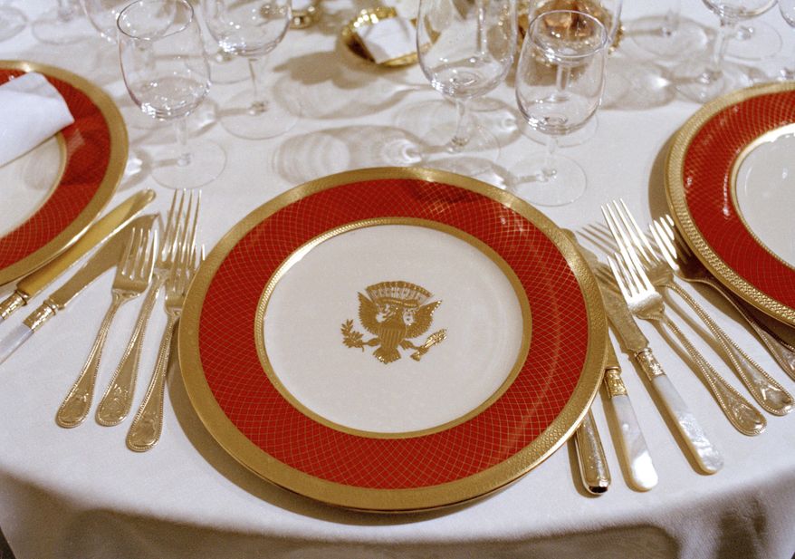 FILE - The new White House china, chosen by first lady Nancy Reagan and purchased for $209,509 through private donations, is unveiled to the press at the White House in Washington, Feb. 3, 1982. The china, as laid out for a state dinner, includes 220 place settings with 4,372 pieces. (AP Photo/Ron Edmonds, File)