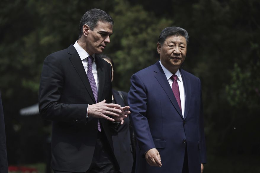 Chinese President Xi Jinping, right and Spanish Prime Minister Pedro Sanchez speak as they walk along the gardens of Diaoyutai Guest House after a meeting in Beijing, China, Friday, April 11, 2025. (Andres Martinez Casares/Pool Photo via AP)