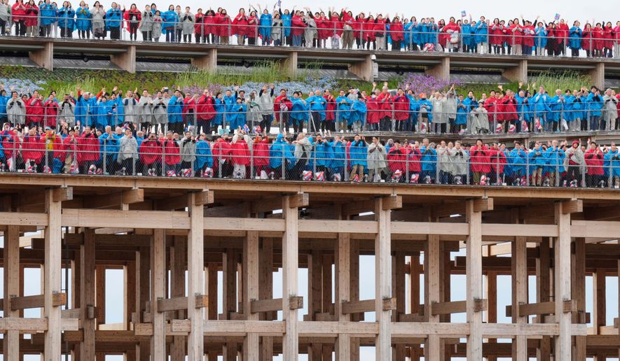 Participants sing Beethoven's "Ode to Joy" on the opening day of Osaka Expo 2025 in Osaka, western Japan, Sunday, April 13, 2025. (AP Photo/Hiro Komae)