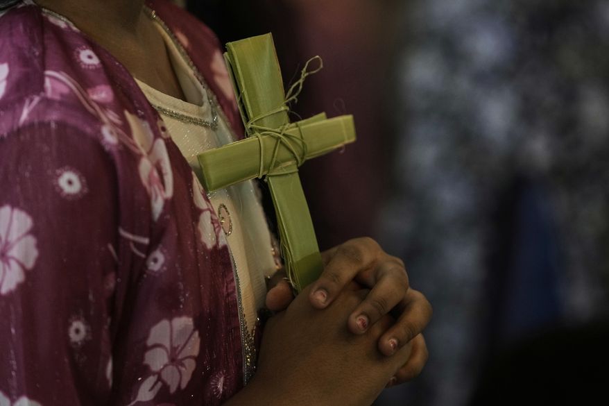 A Catholic holds cross made of blessed palm leaves during a Palm Sunday Service at Mariarani Cathedral in Nalgonda, Telangana State, India, Sunday, April 13, 2025. Palm Sunday marks the sixth and last Sunday of the Christian Holy month of Lent. (AP Photo/Mahesh Kumar A.) **FILE**
