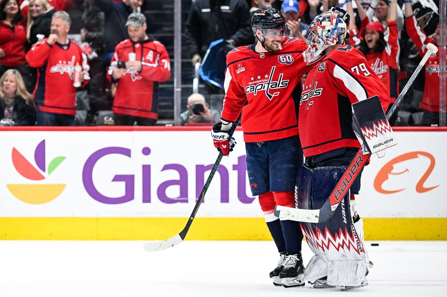 Washington Capitals center Pierre-Luc Dubois (80) congratulates goalie Charlie Lindgren (79) after he stopped all three shootout attempts in a 5-4 victory over the Carolina Hurricanes at Capital One Arena, Washington, D.C., April 10, 2025. (Photo by Brian Murphy for the Washington Times)