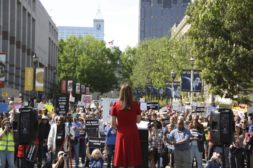 Democratic Associate Justice Allison Riggs stands before more than a hundred supporters at her rally in Raleigh, N.C., on Monday, April 14, 2025. (AP Photo/Makiya Seminera)