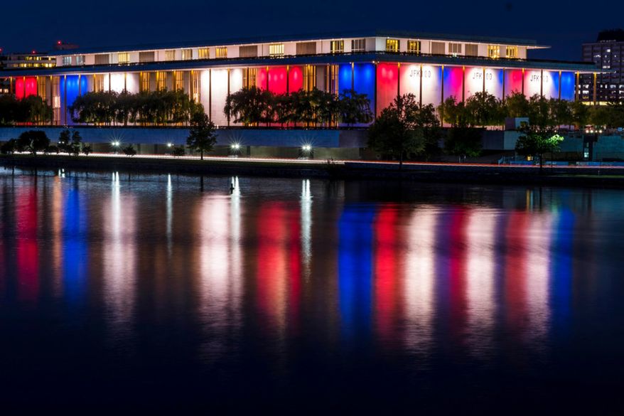 The red, white and blue lights, marking the 100th birthday of President John F. Kennedy, on the outside of the Kennedy Center for the Performing Arts are reflected in the Potomac River in Washington, Friday, May 26, 2017. (AP Photo/J. David Ake)