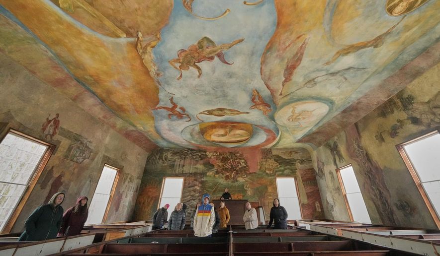 Visitors view the frescoes at the South Solon Meeting House, Sunday, April 6, 2025, in Solon, Maine. (AP Photo/Robert F. Bukaty)