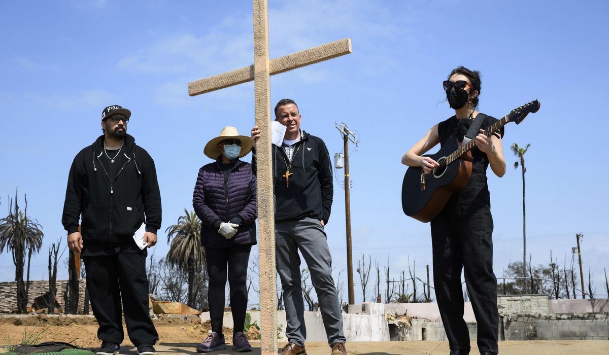 NextImg:Members of burned LA church bear a cross through their devastated neighborhood to mark Good Friday