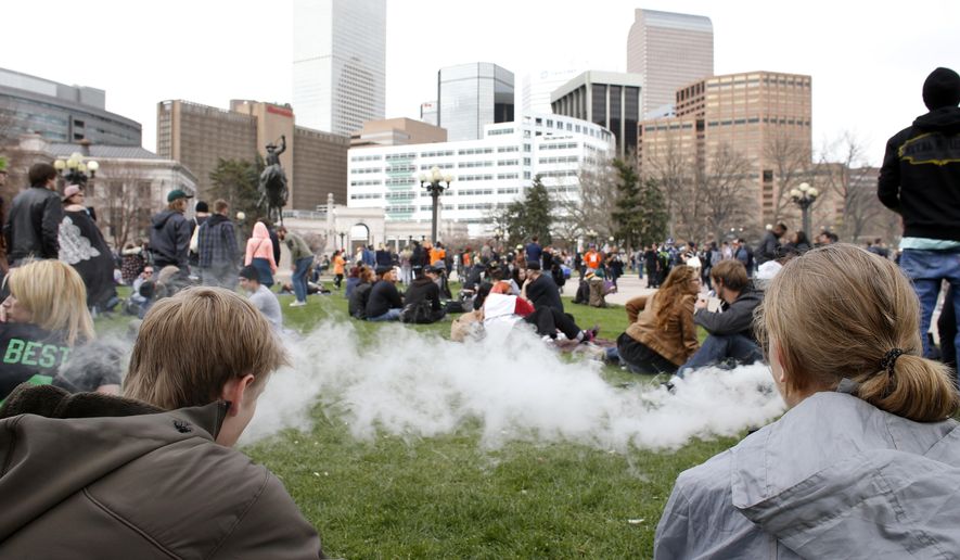People smoke marijuana during the annual 4/20 marijuana gathering at Civic Center Park in downtown Denver on Wednesday, April 20, 2016. (AP Photo/Brennan Linsley) **FILE**