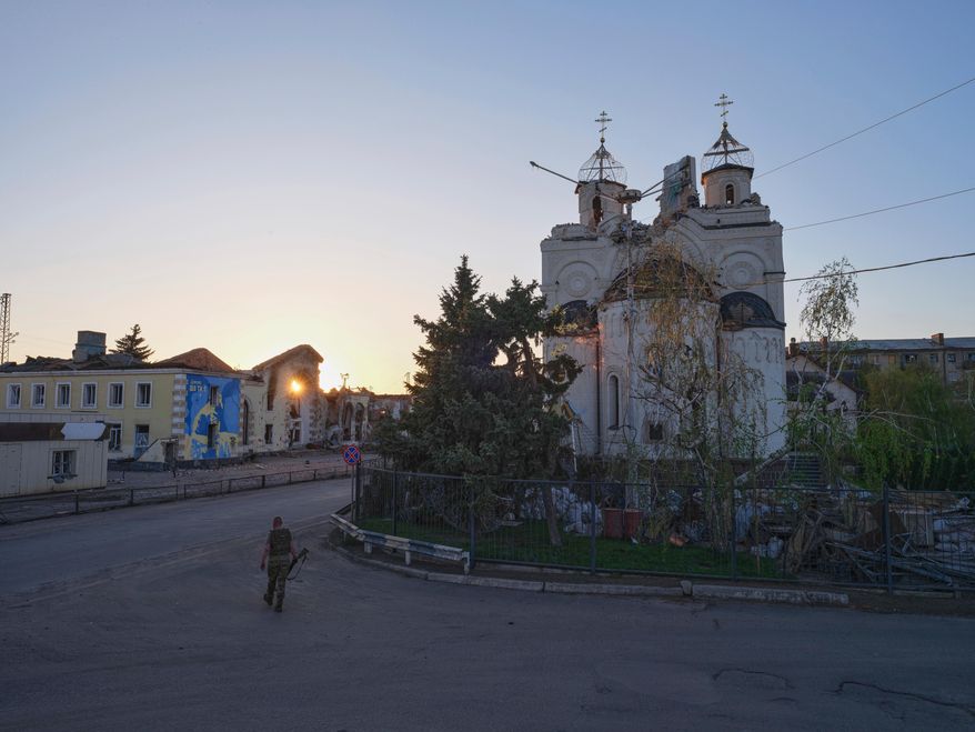 In this photo provided by Ukraine's 93rd Kholodnyi Yar Separate Mechanized Brigade press service, a soldier passes by a damaged church in Kostyantynivka, the site of heavy battles with Russian troops, in the Donetsk region, Ukraine, Saturday, April 19, 2025. (Iryna Rybakova/Ukraine's 93rd Mechanized Brigade via AP)