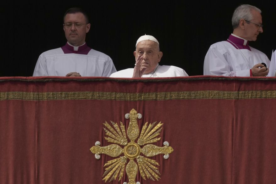 Pope Francis bestows the Urbi et Orbi (Latin for to the city and to the world) blessing from the central lodge of St. Peter's Basilica at the end of the Easter mass presided over by Cardinal Angelo Comastri in St. Peter's Square at the Vatican Sunday, April 20, 2025. (AP Photo/Andrew Medichini)