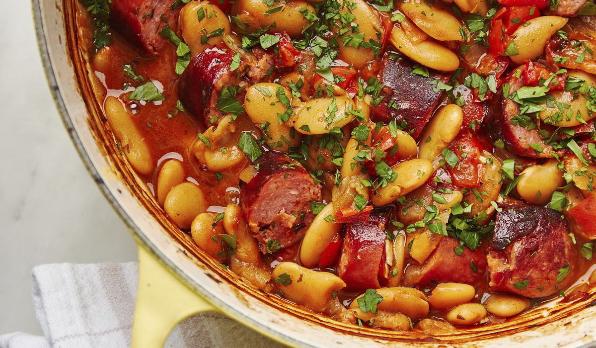 NextImg:This rustic dish of baked beans and smoked sausages is packed with deep, aromatic flavors