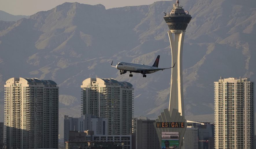 FILE - Delta Air Lines flight lands at Harry Reid International Airport, Wednesday, April 9, 2025, in Las Vegas. (AP Photo/John Locher, File)