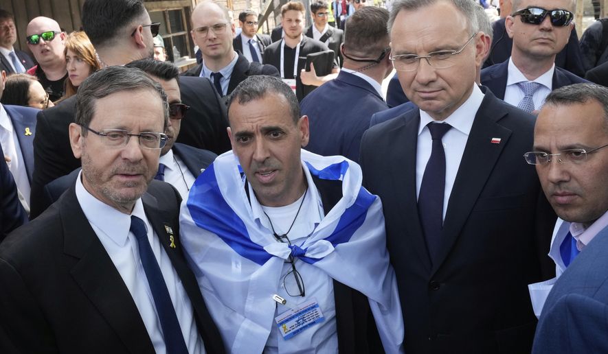 Poland's President Andrzej Duda, right, and his Israel's counterpart Isaac Herzog arrive at the former Nazi German death camp of Auschwitz-Birkenau to attend the "March of the Living", the annual Holocaust remembrance event in memory of the six million Holocaust victims in Oswiecim, Poland, Thursday, April 24, 2025. (AP Photo/Czarek Sokolowski)
