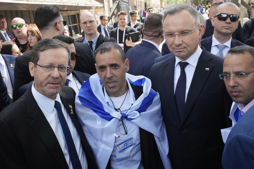 Poland's President Andrzej Duda, right, and his Israel's counterpart Isaac Herzog arrive at the former Nazi German death camp of Auschwitz-Birkenau to attend the "March of the Living", the annual Holocaust remembrance event in memory of the six million Holocaust victims in Oswiecim, Poland, Thursday, April 24, 2025. (AP Photo/Czarek Sokolowski)