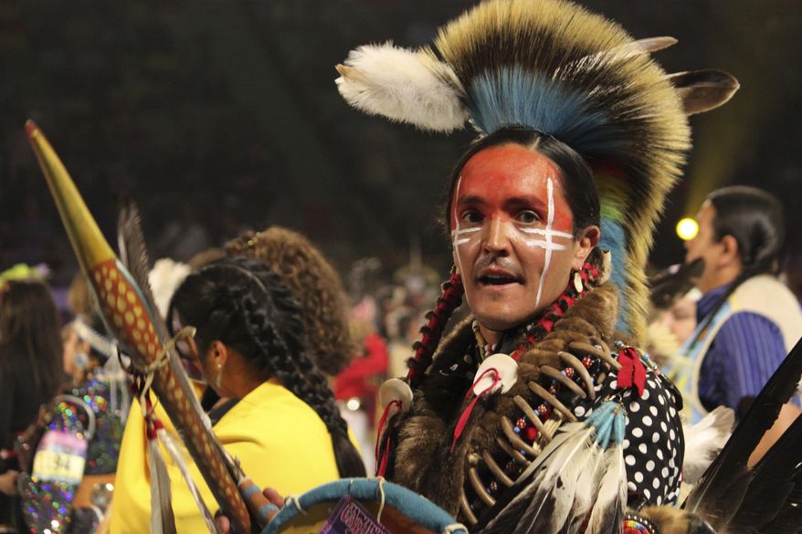 Native American and Indigenous dancers take part in a grand entry procession at the annual Gathering of Nations powwow in Albuquerque, New Mexico, on Friday, May 25, 2025 (AP Photo/Susan Montoya Bryan)