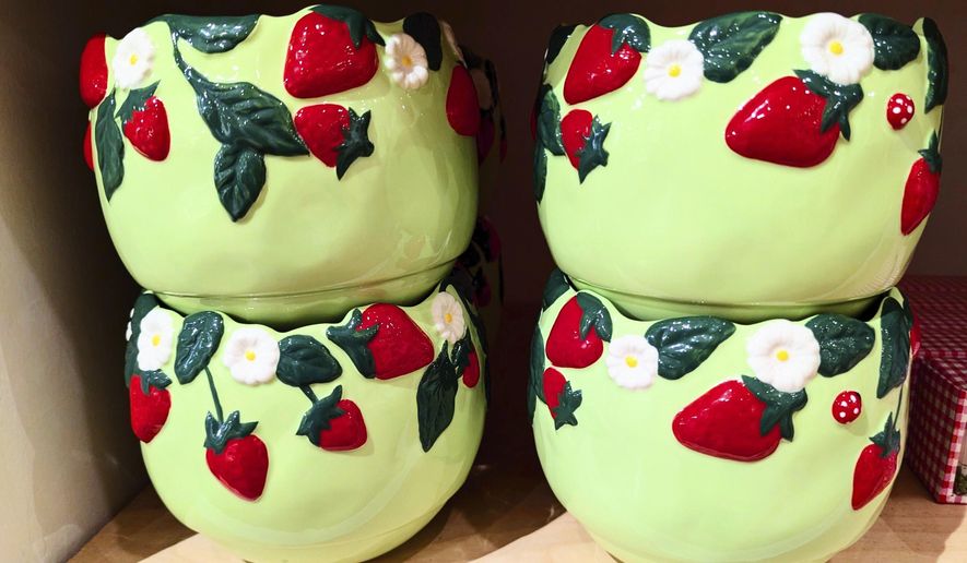 This photo provided by Kim Cook shows a collection of bowls at Anthropologie, decorated with berries. (Kim Cook via AP)