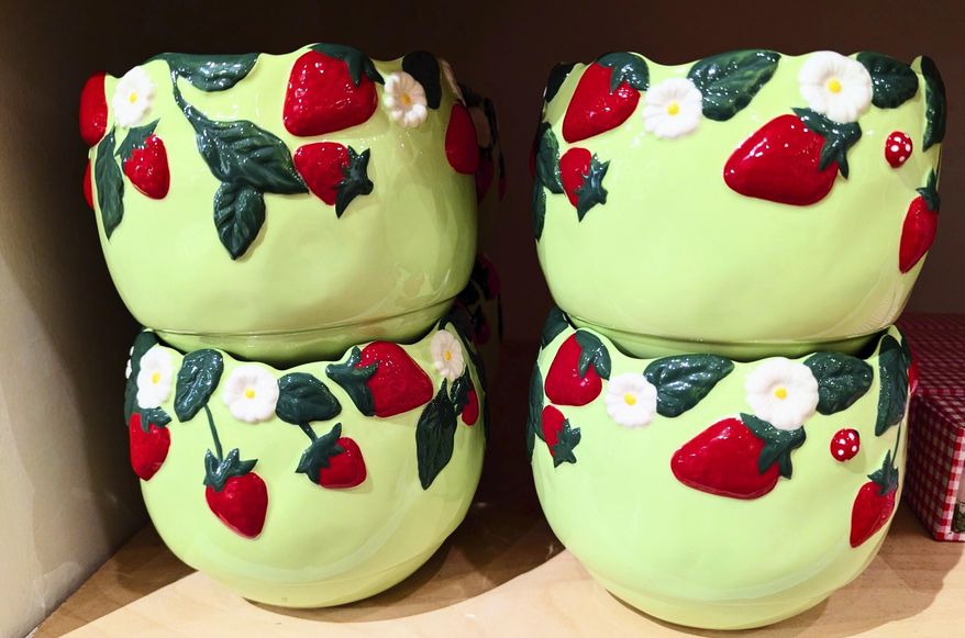 This photo provided by Kim Cook shows a collection of bowls at Anthropologie, decorated with berries. (Kim Cook via AP)
