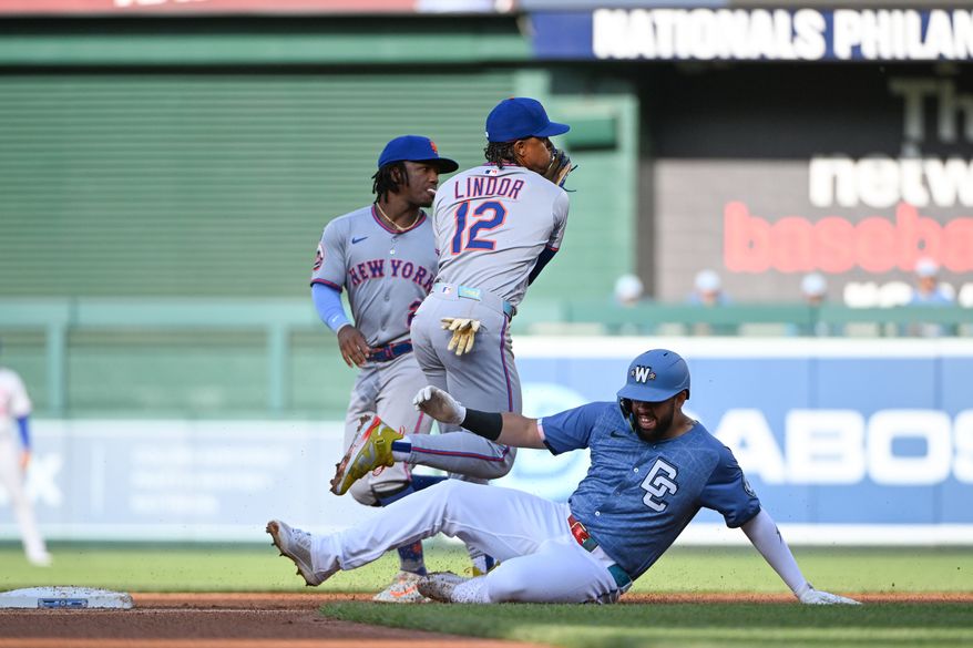 New York Mets shortstop Francisco Lindor (12) throwing to first base to complete a double play as Washington Nationals second baseman Luis Garcia (2) slides into second base during the second inning of an MLB game at Nationals Park in Washington D.C., April 26, 2025. (Photo by All-Pro Reels for Washington Times Sports)