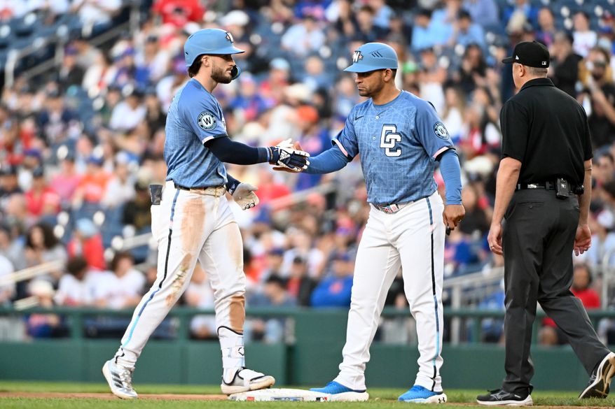 Washington Nationals right fielder Dylan Crews (3) shaking hands with Washington Nationals first base coach Gerardo Parra (88) after hitting a single during the eighth inning of an MLB game against the New York Mets at Nationals Park in Washington D.C., April 26, 2025. (Photo by All-Pro Reels for Washington Times Sports)