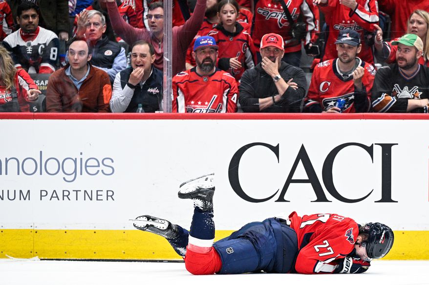 Washington Capitals defenseman Alexander Alexeyev (27) drops to the ice after taking a high stick to the mouth by Montreal Canadiens forward Jake Evans (71) at Capital One Arena, Washington, D.C., April 21, 2025. (Photo by Brian Murphy for the Washington Times)