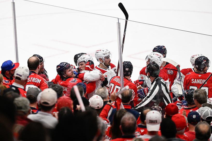 Washington Capitals right wing Taylor Raddysh (16) gets into a skirmish along the boards with Montreal Canadiens left wing Juraj Slafkovsky (20) during a stoppage in play at Capital One Arena, Washington, D.C., April 21, 2025. (Photo by Brian Murphy for the Washington Times)