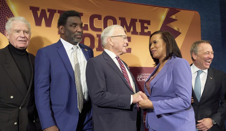 Hall of Fame running back John Riggins, from left, former Washington Commanders quarterback Doug Williams and former coach Joe Gibbs greet District of Columbia Mayor Muriel Bowser, next to Washington Commanders controlling owner Josh Harris, after an announcement that a new home for the NFL football team will be built on the site of the old RFK Stadium, Monday, April 28, 2025, at the National Press Club in Washington. (AP Photo/Jacquelyn Martin) ** FILE **