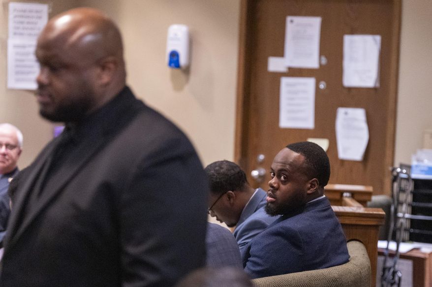 Former Memphis Police Department officer and defendant Tadarrius Bean, right, looks up as Desmond Mills Jr., left, a former MPD officer who has taken a plea deal, walks into the courtroom to take the stand as a witness during the second day of the state trial for the death of Tyre Nichols at 201 Poplar in Memphis, Tenn., on Tuesday, April 29, 2025. (Chris Day/Commercial Appeal/USA Today Network via AP, Pool)