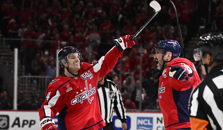Washington Capitals left wing Alex Ovechkin (8), right, celebrates his goal with defenseman John Carlson, left, in the first period of Game 5 of a first-round NHL hockey playoff series against the Montreal Canadiens, Wednesday, April 30, 2025, in Washington. (AP Photo/Nick Wass)