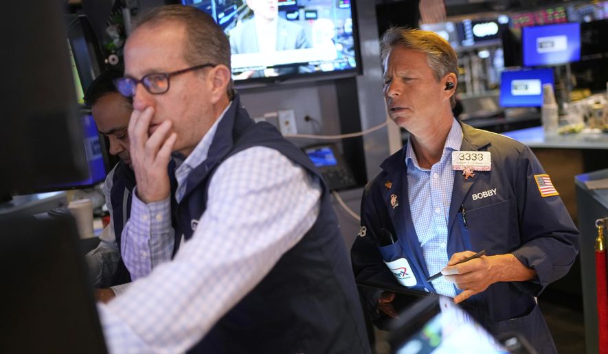 Bobby Charmak, right, works on the floor at the New York Stock Exchange in New York, Wednesday, April 30, 2025. (AP Photo/Seth Wenig)