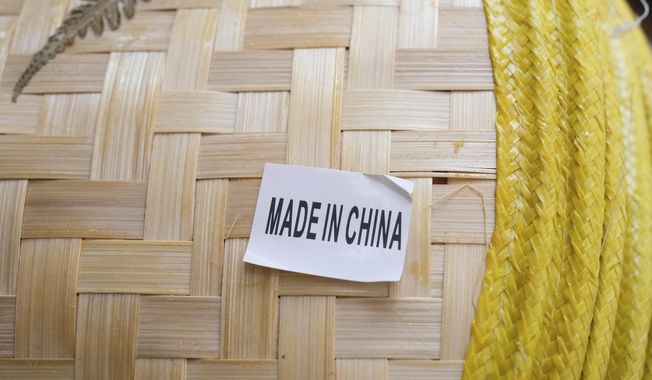 FILE - A made in China sticker is displayed on a hat at a store in Chinatown in San Francisco, April 18, 2025. (AP Photo/Jeff Chiu, File)