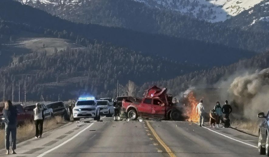 Rescue workers arrive to the scene after a deadly collision between a pickup truck and tour van near Henry’s Lake State Park in eastern Idaho on Thursday, May 1, 2025. (Roger Merrill via AP)