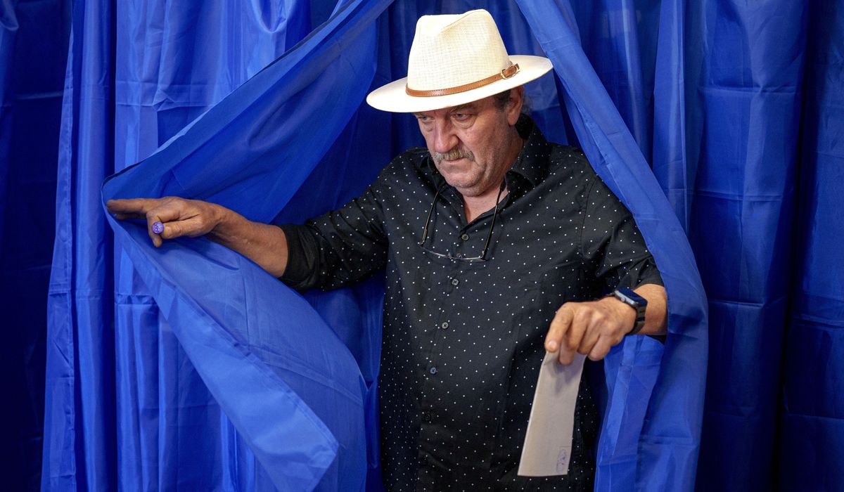 NextImg:Romanians cast votes in presidential rerun after voided election sparked deep political crisis